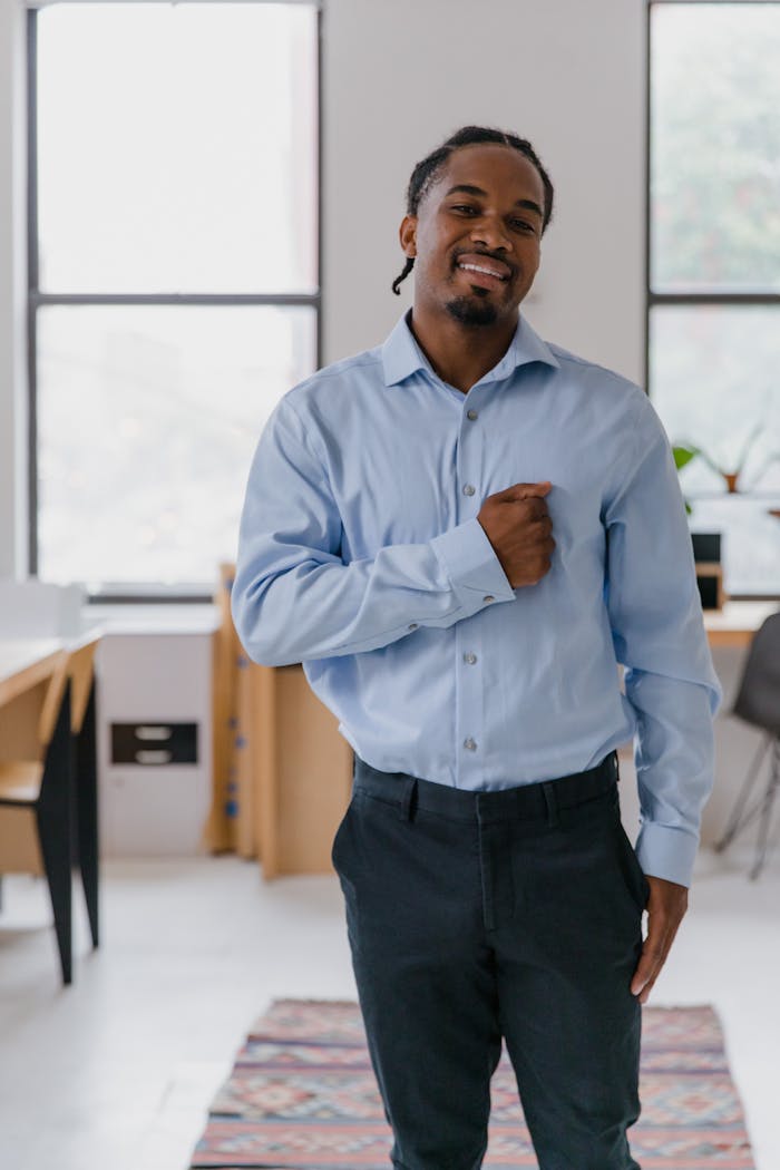 Portrait of a smiling man in a modern office, showcasing confidence and professionalism.